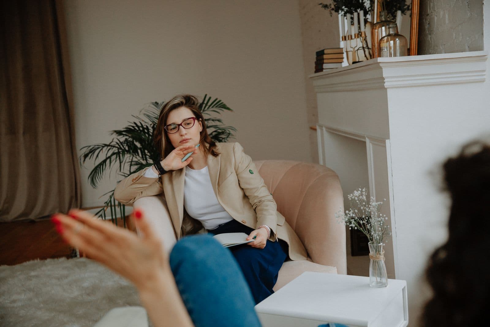 A therapist listening to a client in a warm, calm office